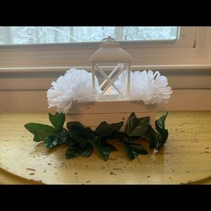 Crate and lantern centerpiece with dark green leaves